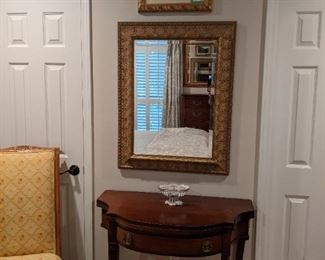 1940's mahogany game table, newer gold wall mirror, with beveled glass, hand-painted oil on canvas above the mirror and a nicely upholstered French walnut side chair.