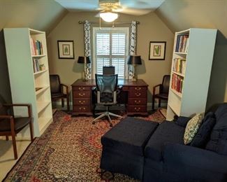 Upstairs office/bonus room area with mahogany desk, which has a tooled leather top, a pair of brass desk lamps, nice pair of framed/matted botanicals, pair of bookshelves with vintage children's books, a set/4 Danish teak/leather armchairs, one of a pair of generously sized upholstered armchairs (one with a matching ottoman), by Fairfield, all atop a wonderful Persian Bidjar rug.
