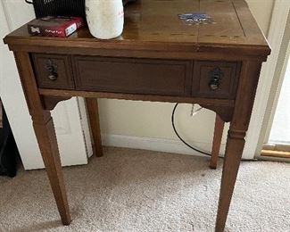 Vintage sewing table / cabinet, sewing machine folds out.