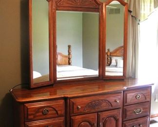 Large tri-fold mirror with matching solid dresser is in excellent condition.