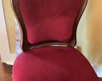 One of six red velvet antique chairs