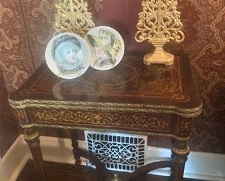 The top of this antique table lifts and then swivels to double the surface size.