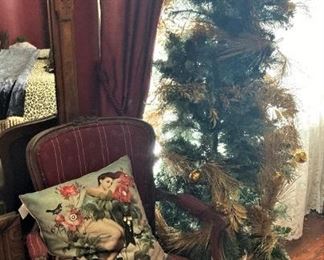 Antique arm chair; Christmas tree and pillow