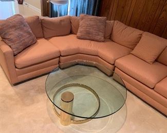 custom-upholstered sectional with brass and glass coffee table