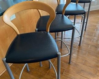 Set of four bar stools. Seat covers are in need of replacing. 
