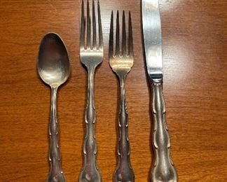 STERLING!  1950's Gorham pattern.  From the replacements website:    "Introduced in 1951, Gorham Rondo is a modern variation of the company's popular Straussburg pattern.  It's classic design features playful scrolls, but is otherwise streamlined and symmetrical"