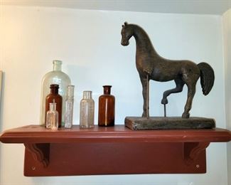 Antique apothecary bottles. Horse statue