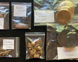 Assorted vintage pocket watch parts including backs and chains