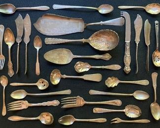 Assorted vintage silver and silver plate utensils and serving pieces