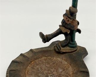 Antique cast iron drunk man on the lightpost ashtray
