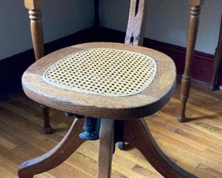 Antique wood and cane rolling desk chair