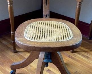 Antique wood and cane rolling desk chair