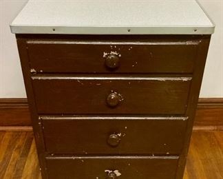 Antique 4-drawer aluminum-edged formica top cabinet