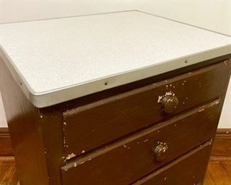 Antique 4-drawer aluminum-edged formica top cabinet