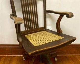 Antique wooden cane bottomed adjustable desk chair