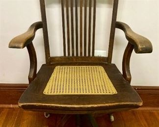 Antique wooden cane bottomed adjustable desk chair