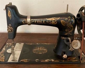 Antique The Free No. 5 sewing machine in oak cabinet