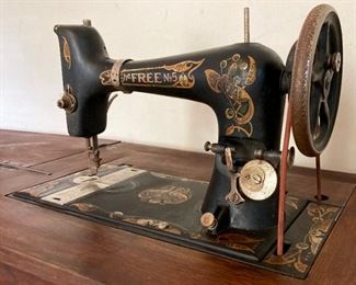 Antique The Free No. 5 sewing machine in oak cabinet