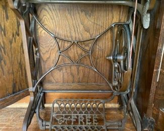 Antique The Free No. 5 sewing machine in oak cabinet