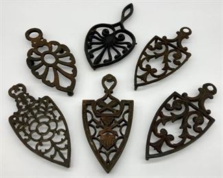 Assorted cast iron and metal trivets