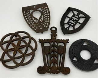 Assorted cast iron and metal trivets