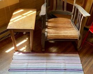 Antique wooden rocker, antique wooden accent table, and multicolored braided rug