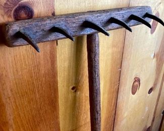 Primitive wood and cast iron rake