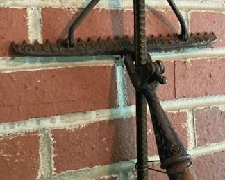 Antique cast iron and wood adjustable length rake by Hinkel Industries
