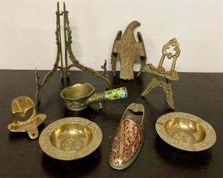 Assorted vintage brass items including plate stands, ashtrays, bottle openers