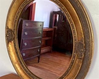 Vintage golden framed beveled oval mirror