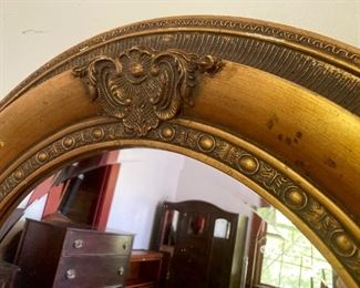 Vintage golden framed beveled oval mirror