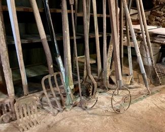 Assorted lawn & garden tools including pitchforks, shovels, rakes, edgers, hoes, etc.