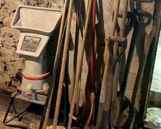 Assorted outdoor tools including shovels, brooms, etc.