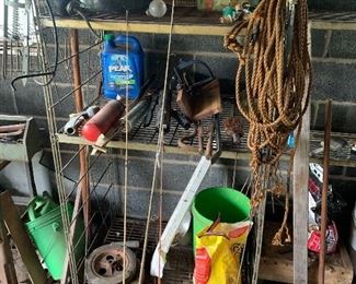 Metal shelving, fishing poles, grease guns