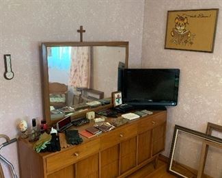 Mid-century modern dresser, television, vintage purses, vintage gloves, picture frames