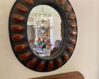 ornate oval metal-framed mirror