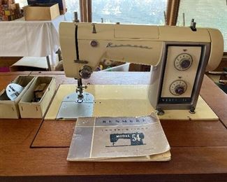 vintage Kenmore Model 54 sewing machine with attachments in MCM cabinet