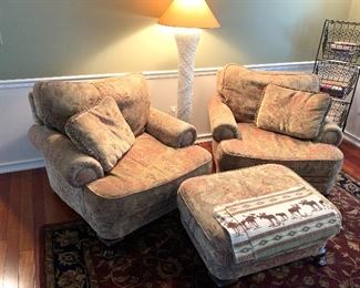 Elegant armchairs and ottoman, rug, blanket, pole lamp