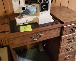 Sewing machine with wood cabinet.
