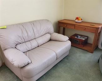 Cream leather love seat, excellent condition.