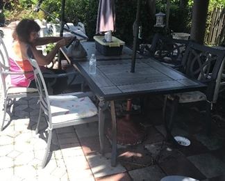 Two tables for 4.  Buy one table or both tables to make a longer table.  5 chairs available.  Umbrellas are available as well.