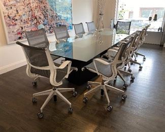 10 Herman Miller chairs
The glass measures 10 feet long 40 inches wide 29 inches tall and it is half an inch thick

Excellent condition there’s no chips or cracks very minimal scratches it’s tempered

Table is custom-made
