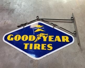 Goodyear Tire 1953 enamel sign. It measures 30.5" by 54" and is in very good condition with just a few small pits around the edge. It has its original metal iron hanging bracket.