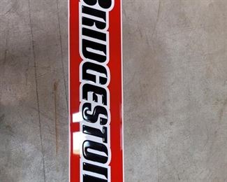 A High Quality Bridgestone Stamped Metal 1-sided sign that measures 9.5" by 48". The sign is in very good condition.