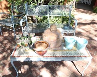 Pots, wrought iron furniture, mosiac table