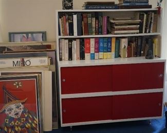 assorted artwork, books and bookcase