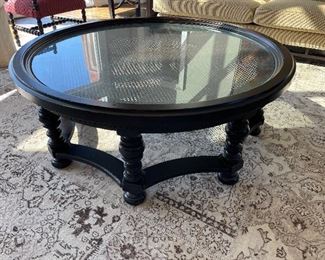 54” round coffee table with glass covered cane surface 