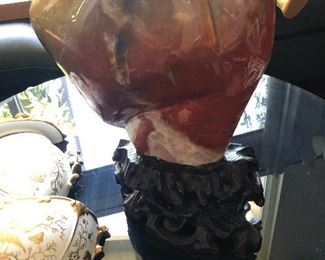 Large polished stone sculpture on wood base