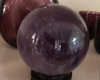 Polished amethyst orb on stand