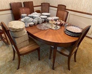 Kindel dining table with three leaves, six chairs and pads.